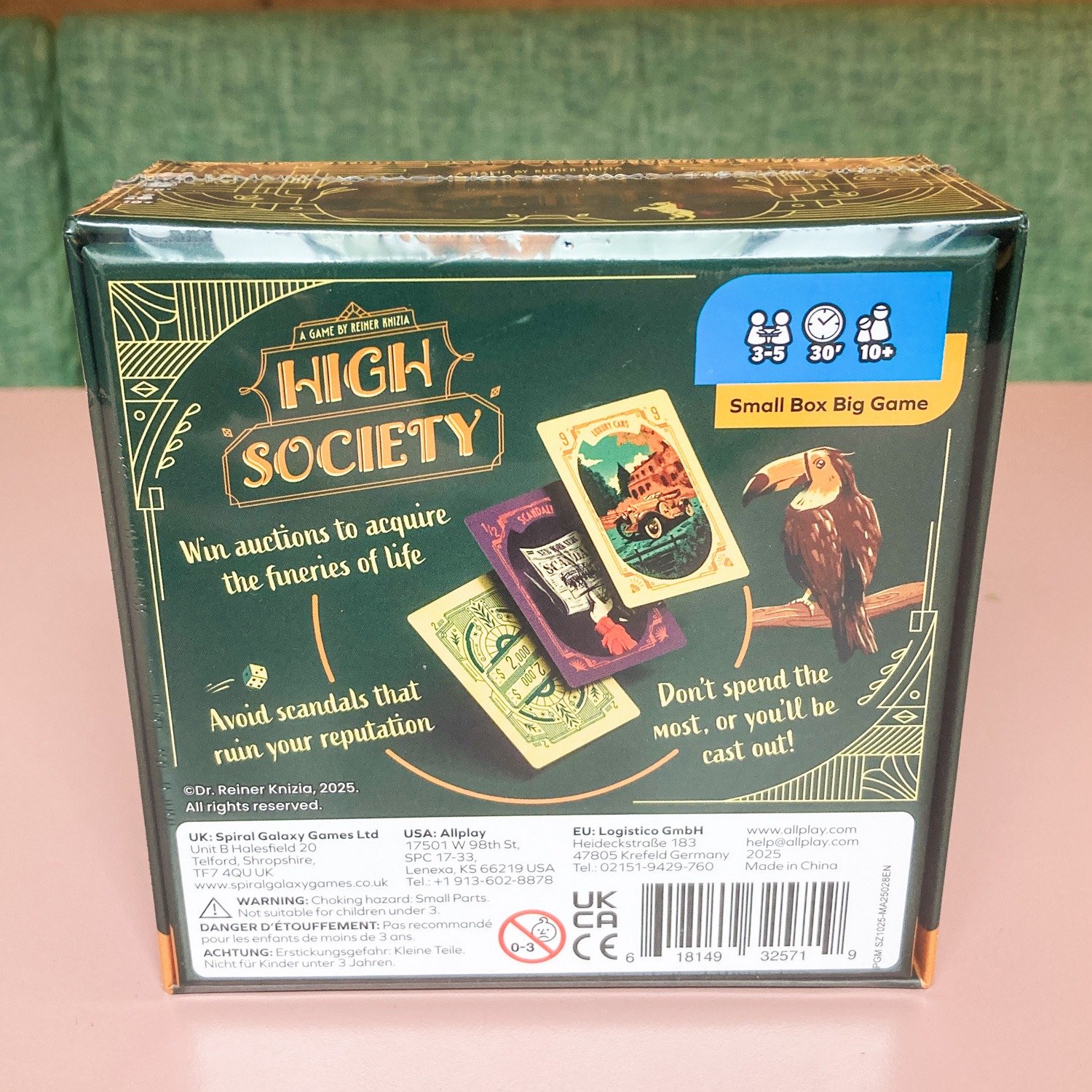HIGH_SOCIETY_BACK - Chance & Counters Box for the card game High Society with vintage artwork, showing playing cards and a toucan on the right side.